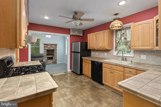 150 Coolidge Ave, Lawrence Township, NJ 08648 - kitchen with black dishwasher, freestanding refrigerator, gas range, a brick fireplace, and ceiling fan