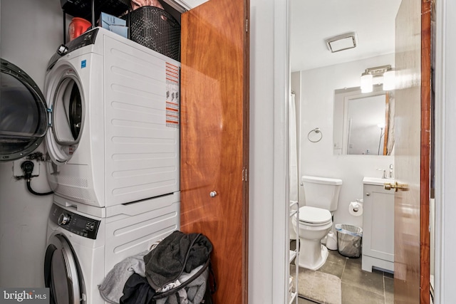 1917 Spring Garden St, Philadelphia, PA 19130 - washroom with stacked washer / dryer and tile patterned floors