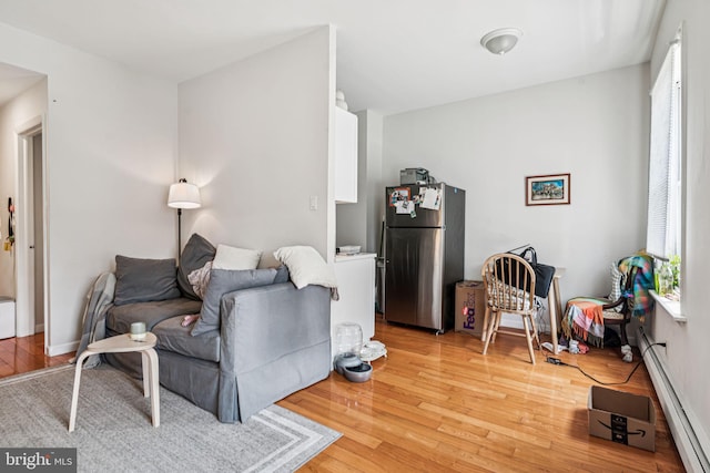 1917 Spring Garden St, Philadelphia, PA 19130 - living area featuring light wood finished floors and a baseboard radiator