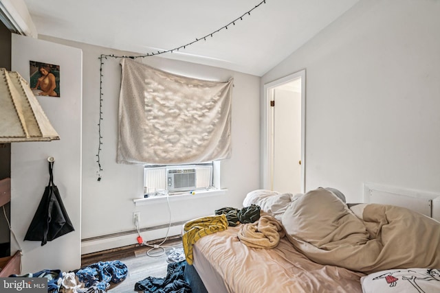 1917 Spring Garden St, Philadelphia, PA 19130 - bedroom with a baseboard heating unit, cooling unit, vaulted ceiling, and wood finished floors