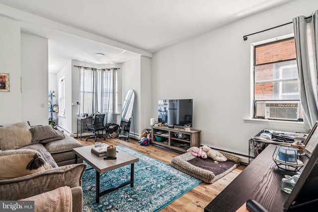 1917 Spring Garden St, Philadelphia, PA 19130 - living area with cooling unit, wood finished floors, and a baseboard radiator