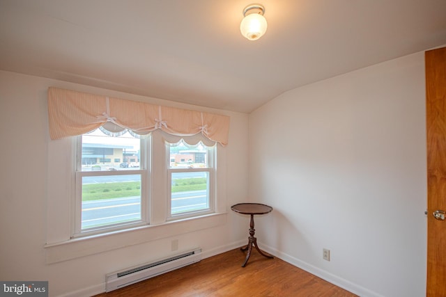 24981 Delmar Rd, Mardela Springs, MD 21837 - unfurnished dining area with a baseboard heating unit, light wood-style floors, and vaulted ceiling