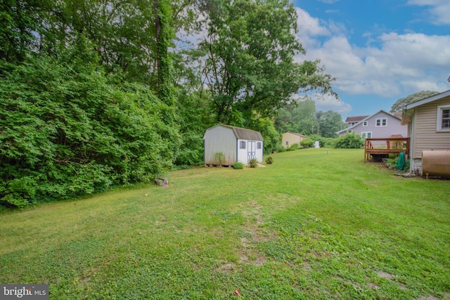 24981 Delmar Rd, Mardela Springs, MD 21837 - view of green lawn featuring a storage shed, a wooden deck, and heating fuel