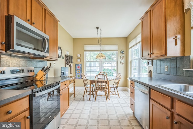 3132 Arbour Green Ct, Hatfield, PA 19440 - kitchen featuring stainless steel appliances, light floors, brown cabinets, and plenty of natural light