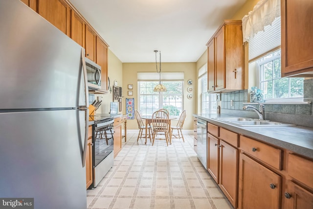3132 Arbour Green Ct, Hatfield, PA 19440 - kitchen with stainless steel appliances, brown cabinets, pendant lighting, backsplash, and light floors