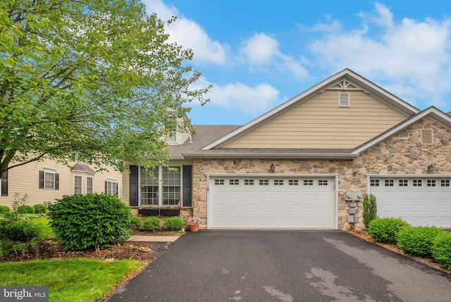 3132 Arbour Green Ct, Hatfield, PA 19440 - view of front facade featuring stone siding, asphalt driveway, an attached garage, and a shingled roof