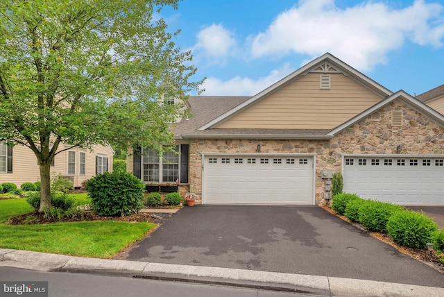 3132 Arbour Green Ct, Hatfield, PA 19440 - view of front of home with stone siding, driveway, a garage, and a shingled roof