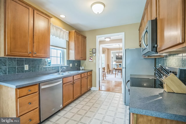 3132 Arbour Green Ct, Hatfield, PA 19440 - kitchen with stainless steel appliances, brown cabinets, backsplash, light floors, and a chandelier