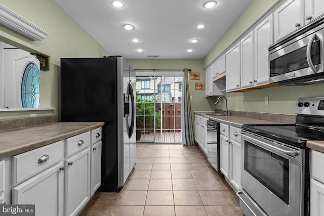 2109 Sturbridge Cmn, Holland, PA 18966 - kitchen with appliances with stainless steel finishes, recessed lighting, white cabinetry, and light tile patterned flooring