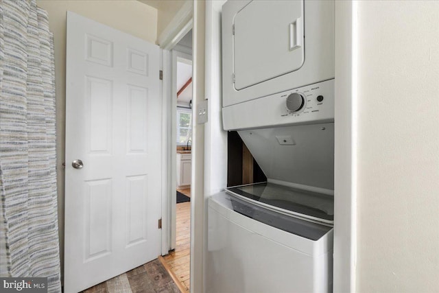 132 Erie Trl, Winchester, VA 22602 - washroom with stacked washer / dryer and wood finished floors
