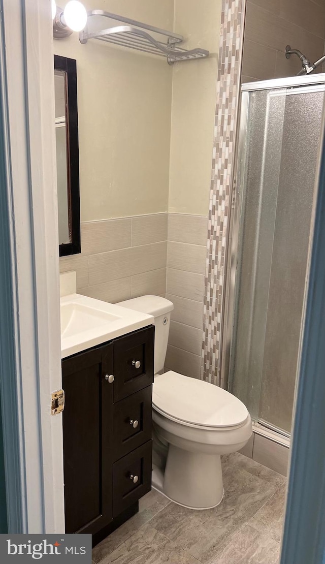 140 Joyceton Ter, Upper Marlboro, MD 20774 - full bathroom with a shower stall, tile walls, vanity, and wainscoting