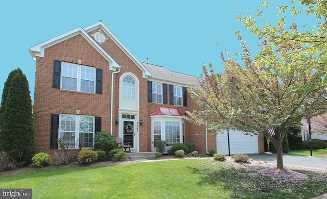 9045 Clendenin Way, Frederick, MD 21704 - colonial house featuring driveway, a front lawn, and brick siding