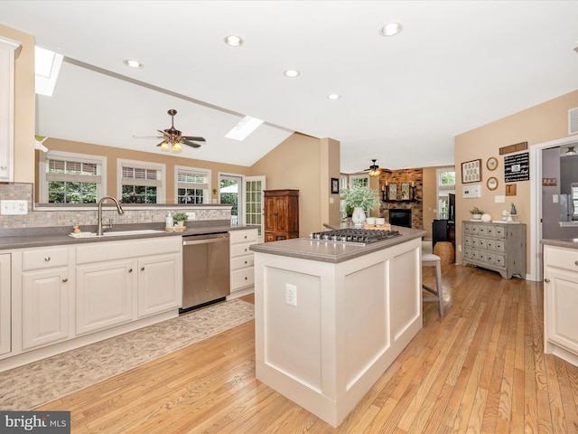 9045 Clendenin Way, Frederick, MD 21704 - kitchen with appliances with stainless steel finishes, ceiling fan, a skylight, a fireplace, and vaulted ceiling