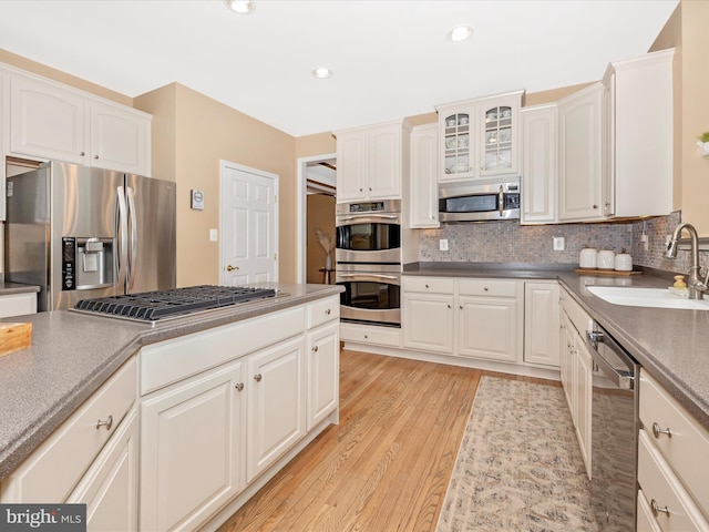 9045 Clendenin Way, Frederick, MD 21704 - kitchen with appliances with stainless steel finishes, light wood-style floors, decorative backsplash, white cabinetry, and recessed lighting