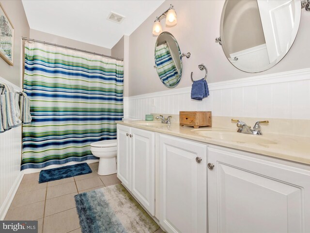 9045 Clendenin Way, Frederick, MD 21704 - bathroom with double vanity, tile patterned floors, wainscoting, and curtained shower