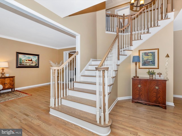 9045 Clendenin Way, Frederick, MD 21704 - staircase featuring wood finished floors, crown molding, and a chandelier