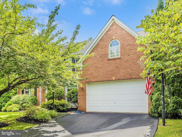 9045 Clendenin Way, Frederick, MD 21704 - view of home's exterior with brick siding, driveway, and a garage