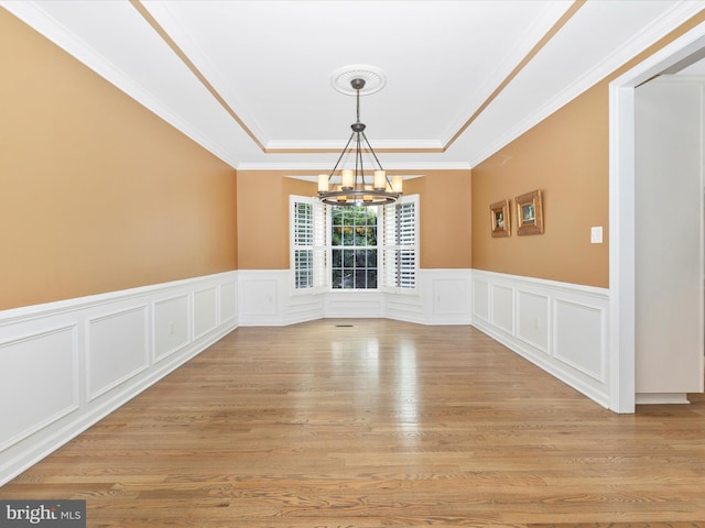 9045 Clendenin Way, Frederick, MD 21704 - empty room featuring a chandelier, a tray ceiling, a decorative wall, light wood finished floors, and wainscoting