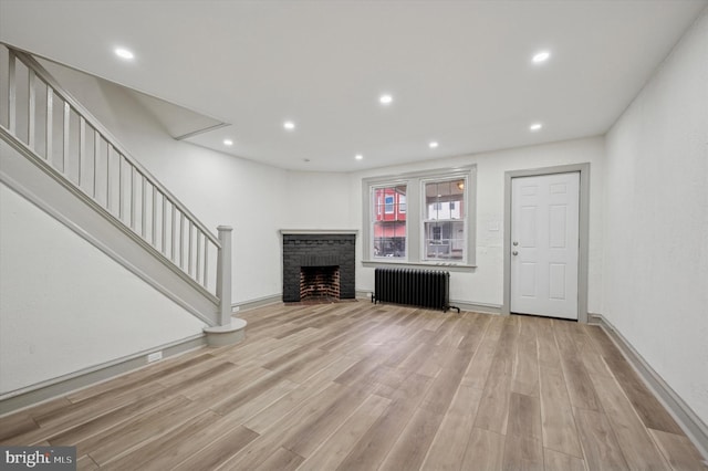 5852 Crittenden St, Philadelphia, PA 19138 - unfurnished living room with radiator heating unit, light wood-type flooring, stairway, and recessed lighting