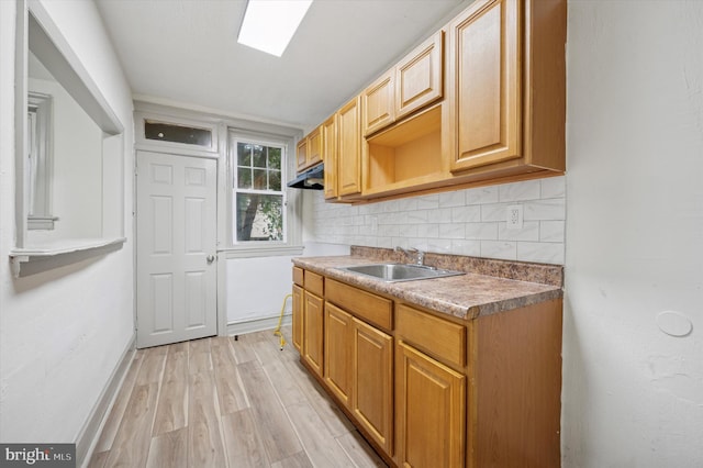 5852 Crittenden St, Philadelphia, PA 19138 - kitchen with tasteful backsplash, light wood-type flooring, and under cabinet range hood