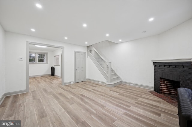 5852 Crittenden St, Philadelphia, PA 19138 - unfurnished living room with light wood-type flooring, stairs, recessed lighting, and a brick fireplace