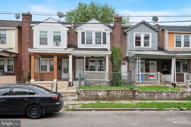 5852 Crittenden St, Philadelphia, PA 19138 - townhome / multi-family property featuring covered porch, brick siding, and cooling unit
