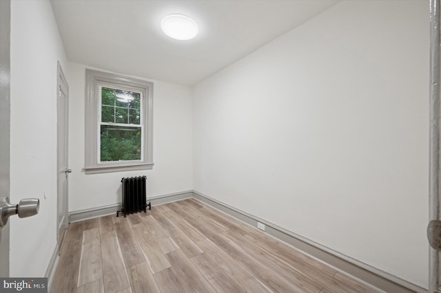 5852 Crittenden St, Philadelphia, PA 19138 - empty room with radiator heating unit and light wood-style flooring
