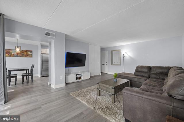 401 Cooper Landing Rd Unit 225, Cherry Hill, NJ 08002 - living area with wood finished floors and baseboards