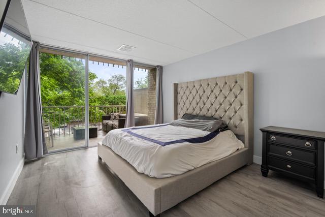 401 Cooper Landing Rd Unit 225, Cherry Hill, NJ 08002 - bedroom with access to outside, wood finished floors, and expansive windows