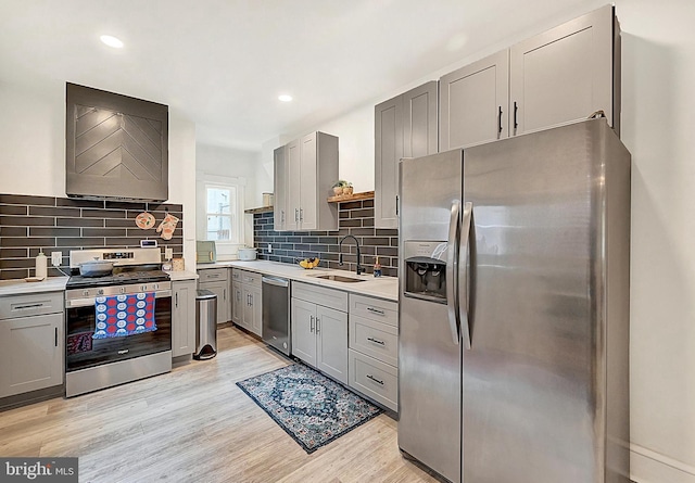 528 N St, Lancaster, PA 17602 - kitchen featuring stainless steel appliances, gray cabinets, light countertops, light wood-style floors, and premium range hood