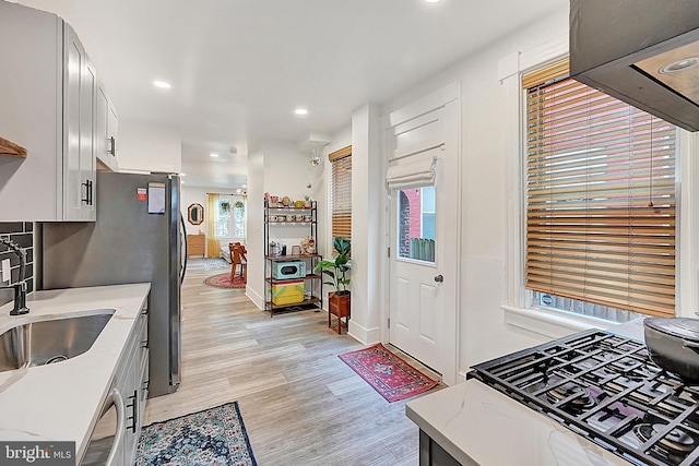 528 N St, Lancaster, PA 17602 - kitchen featuring light wood-type flooring, light stone counters, recessed lighting, freestanding refrigerator, and white cabinets