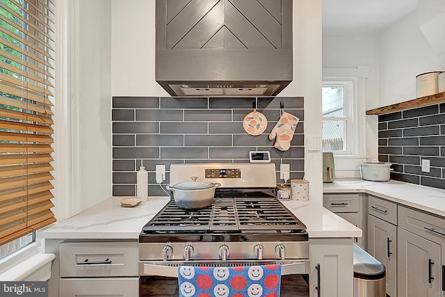 528 N St, Lancaster, PA 17602 - kitchen with custom range hood, stainless steel gas range oven, decorative backsplash, and light stone countertops