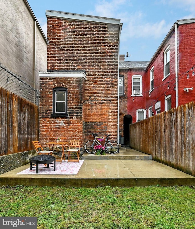528 N St, Lancaster, PA 17602 - rear view of property featuring brick siding and a patio