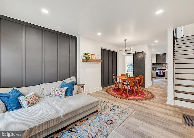 528 N St, Lancaster, PA 17602 - living room with a barn door, stairs, light wood-style flooring, and recessed lighting