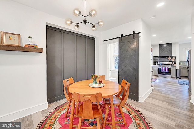 528 N St, Lancaster, PA 17602 - dining area with a barn door, healthy amount of natural light, light wood-style flooring, a chandelier, and recessed lighting