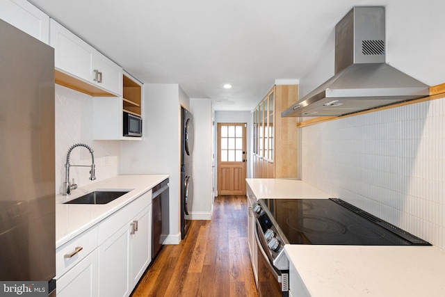 4102 N W St, Wilmington, DE 19802 - kitchen featuring appliances with stainless steel finishes, wall chimney exhaust hood, tasteful backsplash, wood finished floors, and recessed lighting