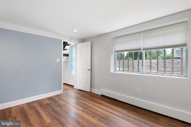 4102 N W St, Wilmington, DE 19802 - empty room featuring a baseboard heating unit, healthy amount of natural light, recessed lighting, and wood finished floors