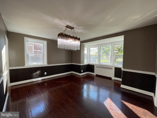 4102 N W St, Wilmington, DE 19802 - unfurnished room with radiator heating unit, hardwood / wood-style floors, plenty of natural light, and a chandelier