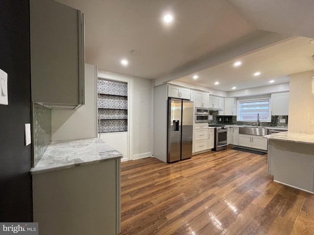 4102 N W St, Wilmington, DE 19802 - kitchen featuring stainless steel appliances, tasteful backsplash, dark wood finished floors, light stone counters, and recessed lighting