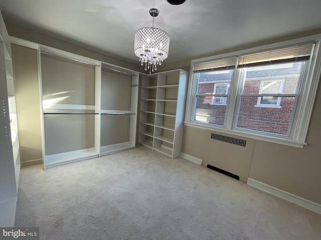 4102 N W St, Wilmington, DE 19802 - spare room with a chandelier, carpet, and radiator heating unit