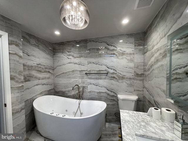 4102 N W St, Wilmington, DE 19802 - bathroom featuring stone wall, marble tiled floors, a freestanding bath, recessed lighting, and tile walls