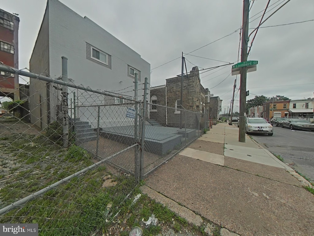 2045 W Toronto St, Philadelphia, PA 19132 - view of side of home with stucco siding and a gate