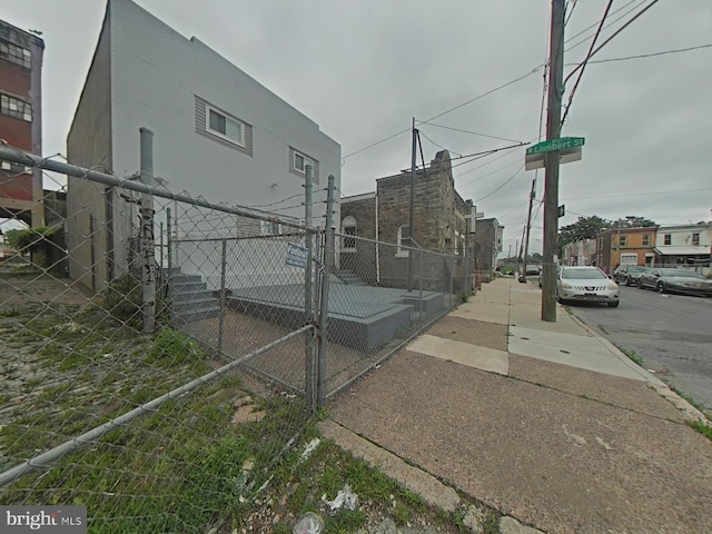 2045 W Toronto St, Philadelphia, PA 19132 - view of side of home with stucco siding and a gate