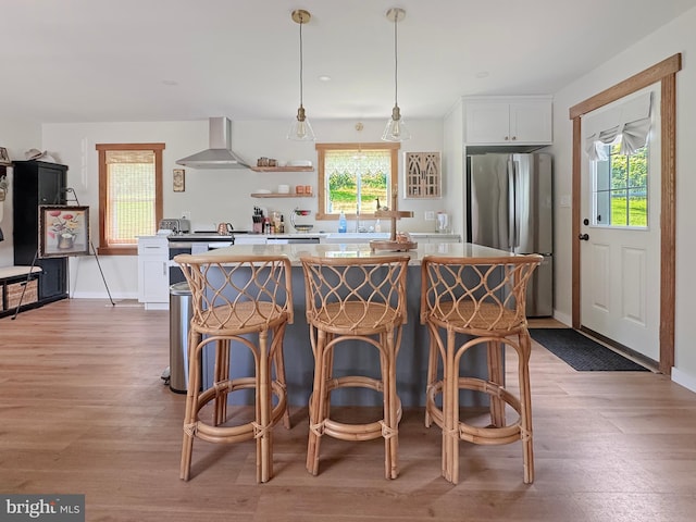 680 Myers Rd, Muncy Valley, PA 17758 - kitchen featuring freestanding refrigerator, wall chimney exhaust hood, plenty of natural light, and a kitchen island