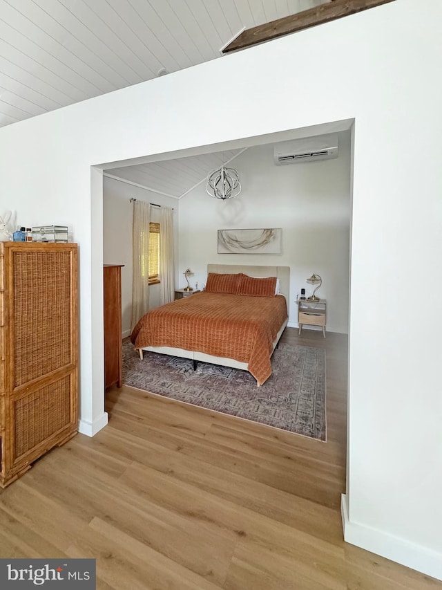 680 Myers Rd, Muncy Valley, PA 17758 - bedroom featuring a wall unit AC, wood finished floors, and vaulted ceiling