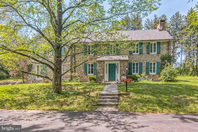 2622 Butler Pike, Plymouth Meeting, PA 19462 - colonial home with a chimney, a front yard, and stone siding
