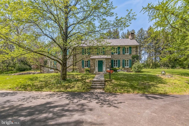 2622 Butler Pike, Plymouth Meeting, PA 19462 - colonial-style house with a chimney, a front yard, and stone siding