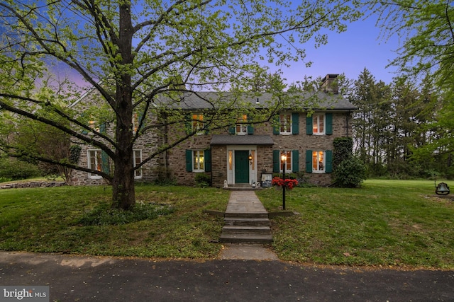 2622 Butler Pike, Plymouth Meeting, PA 19462 - view of front of house featuring a chimney, a lawn, stone siding, and brick siding