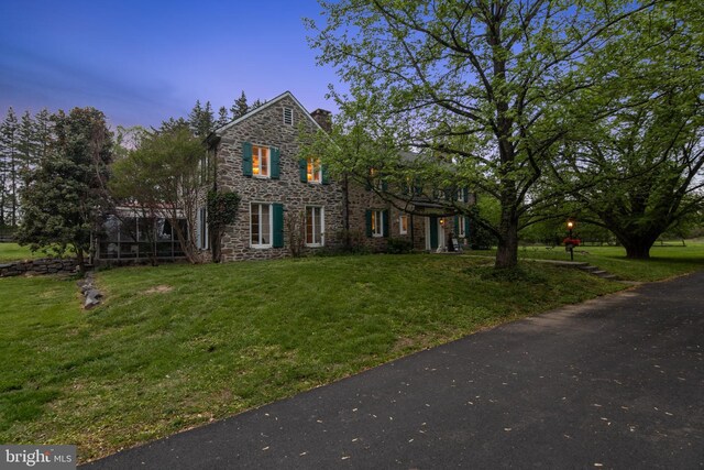 2622 Butler Pike, Plymouth Meeting, PA 19462 - view of front of home with stone siding, a chimney, and a yard