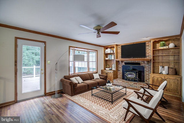 9708 S Park Cir, Fairfax Station, VA 22039 - living room with a wood stove, ceiling fan, crown molding, built in features, and wood-type flooring